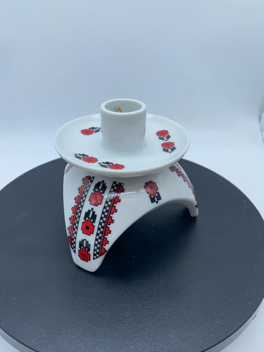 #3412 White ceramic candle holder with red and black Ukrainian folk art motifs.