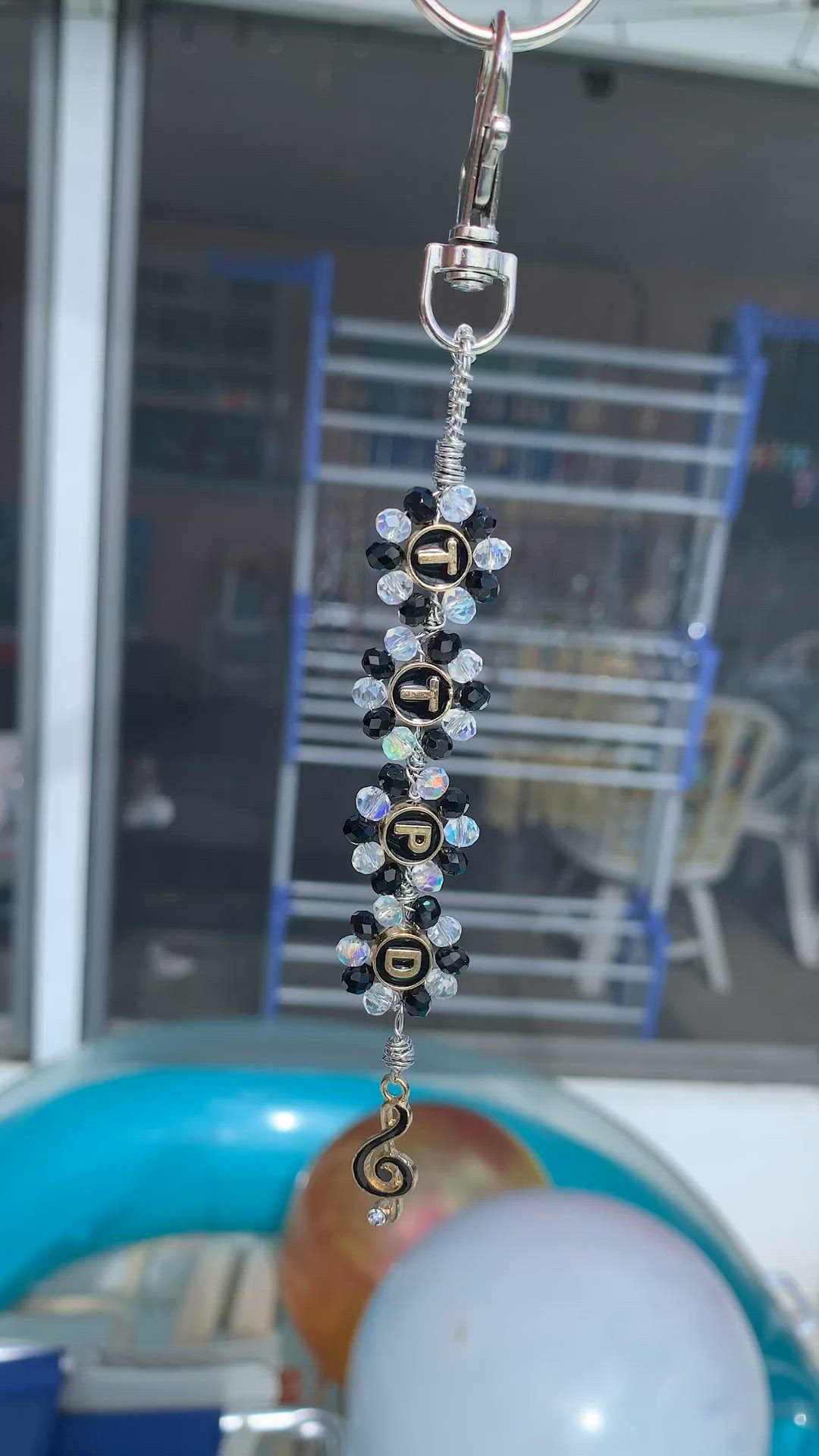 One Of A Kind
Purse/Backpack/Rearview Mirror Charm Or Keychain

40 Alternating Black/Clear Crystals Hand Wrapped Around Alloy TTPD Letters

Hand Wrapped Top Bail

Hand Wrapped Lower Bail W Music Note Dangle